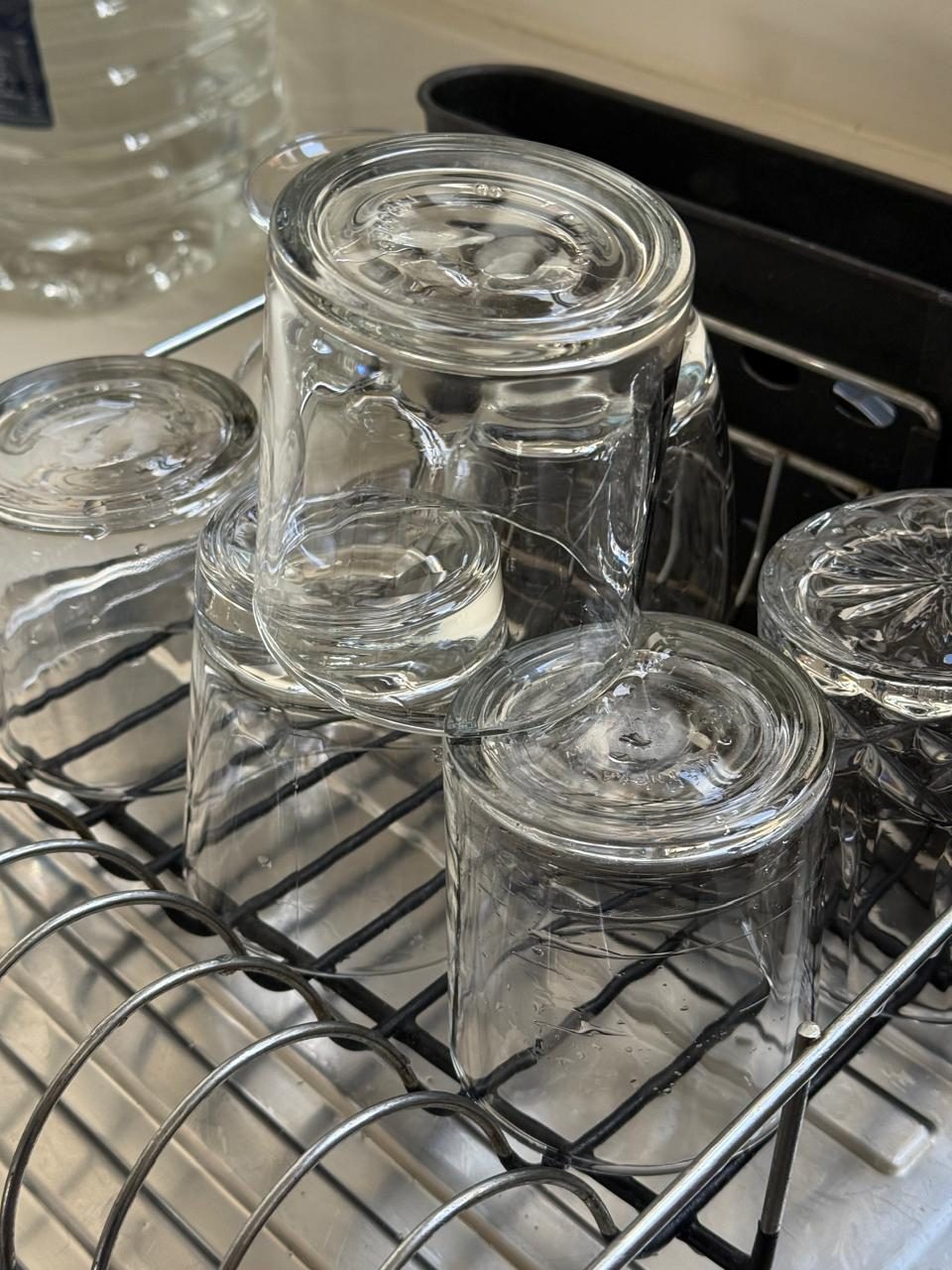 Polished glassware arranged neatly on a drying rack