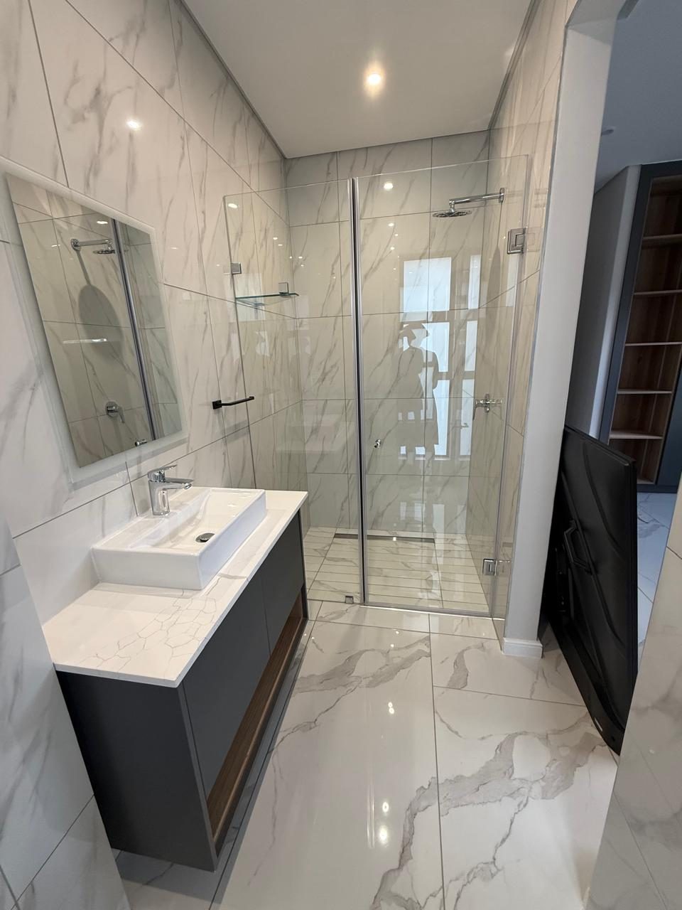 Luxury bathroom with polished vanity and glass shower